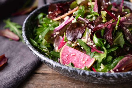 Bowl with couscous and vegetables on wooden background, closeup