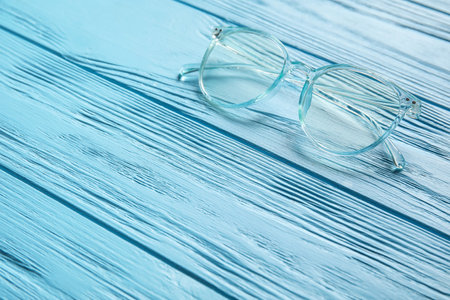 Stylish eyeglasses on color wooden backgroundの写真素材