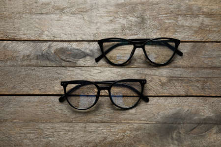 Different stylish eyeglasses on wooden backgroundの写真素材