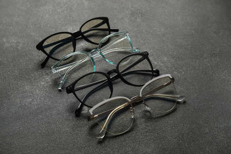 Different stylish eyeglasses on dark backgroundの写真素材