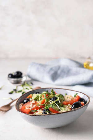 Bowl with couscous and vegetables on light backgroundの写真素材