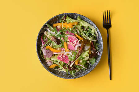 Bowl with couscous and vegetables on color backgroundの写真素材