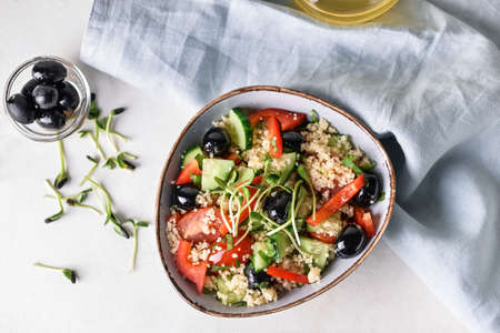 Bowl with couscous and vegetables on light backgroundの写真素材