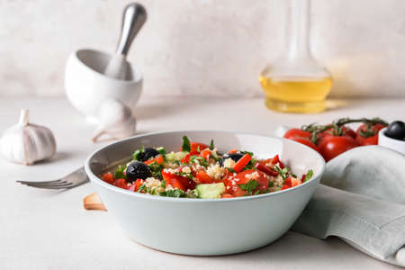 Bowl with couscous and vegetables on light backgroundの写真素材