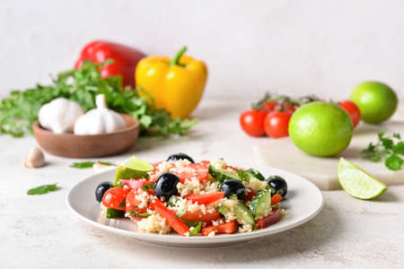 Plate with couscous and vegetables on light backgroundの写真素材