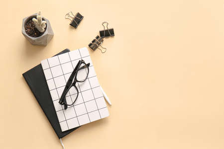 Different office tools and glasses on color tableの写真素材
