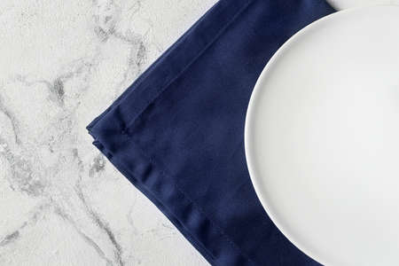 Plate and stylish napkin on light background, closeup