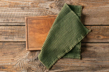 Stylish napkin and board on wooden backgroundの写真素材