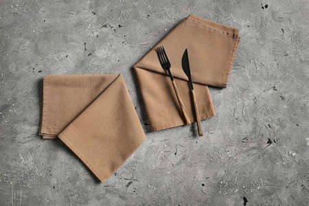 Cutlery and stylish napkins on grunge backgroundの写真素材