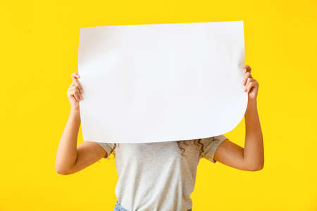 Young woman with blank poster on color backgroundの写真素材