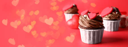 Tasty chocolate cupcakes for Valentine's Day on red background with space for textの写真素材