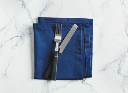 Stylish napkin and cutlery on light backgroundの写真素材