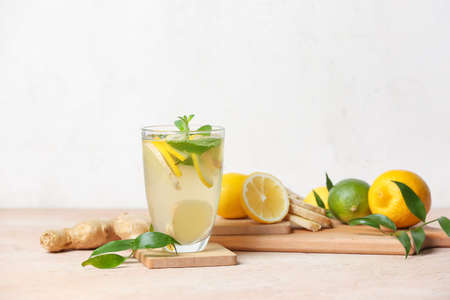 Glass of cold ginger lemonade on tableの写真素材