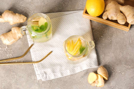 Mason jars of cold ginger lemonade on grunge background