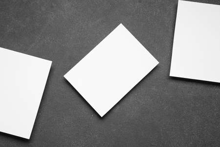 Blank sheets of paper on dark background