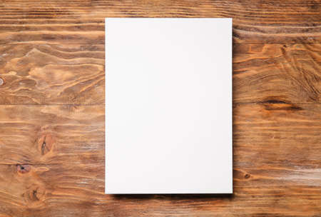 Blank sheet of paper on wooden background