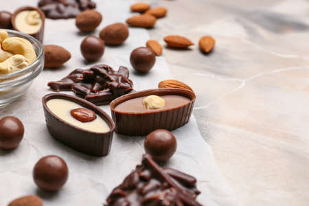 Different chocolate candies on grunge background, closeup