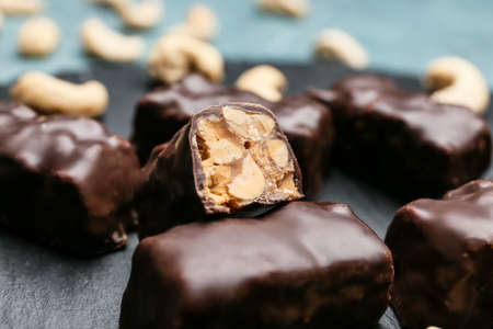 Tasty chocolate candies with nuts on table, closeupの写真素材