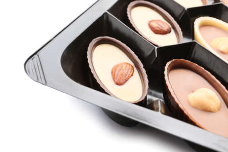 Box with tasty chocolate candies on white background, closeupの写真素材