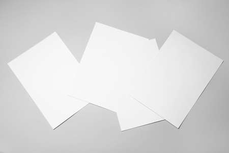 Blank sheets of paper on gray background