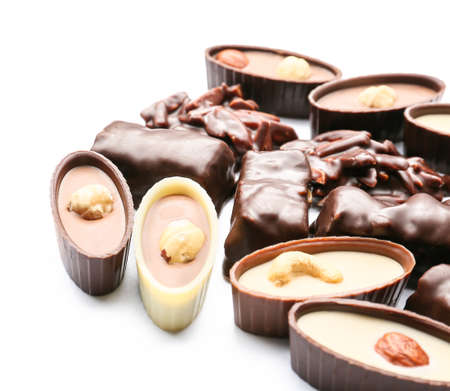 Different chocolate candies on white background, closeup