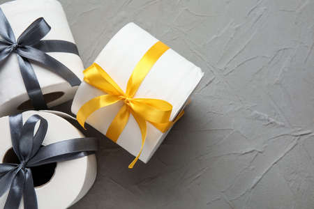 Rolls of toilet paper with ribbon on dark backgroundの写真素材