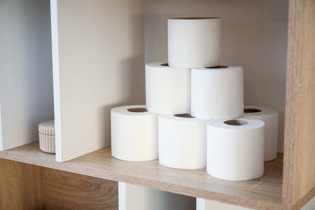 Rolls of toilet paper on shelf in bathroomの写真素材