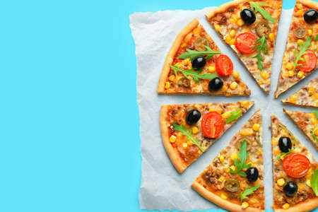 Parchment with tasty pizza on color backgroundの写真素材