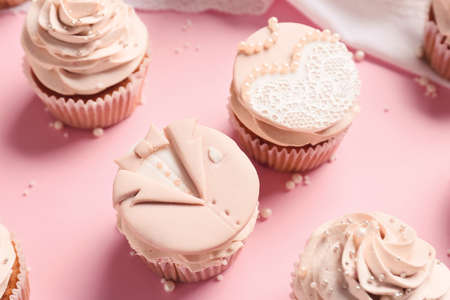 Tasty wedding cupcakes on color backgroundの写真素材