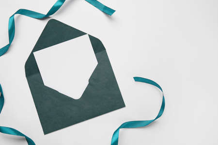 Envelope with blank card and ribbon on white backgroundの写真素材
