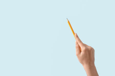 woman with pencil on color backgroundの写真素材