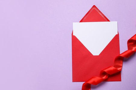 Envelope with blank card and ribbon on color backgroundの写真素材