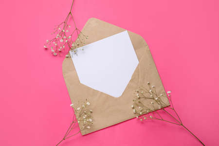 Envelope with blank card and flowers on color backgroundの写真素材