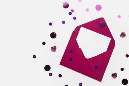 Envelope with blank card and confetti on white backgroundの写真素材