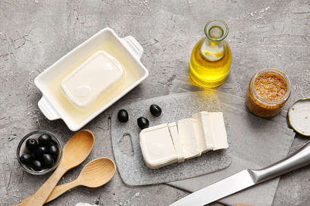 Board with feta cheese on gray backgroundの写真素材