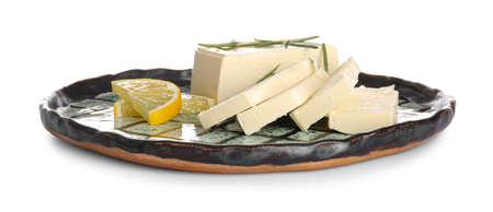 Plate with cut feta cheese, rosemary and lemon on white backgroundの写真素材