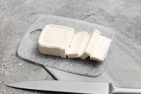 Board with feta cheese on gray backgroundの写真素材