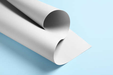 Rolled paper sheet on color backgroundの写真素材