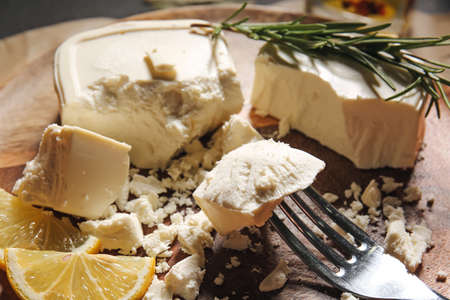 Board with fork and crushed feta cheese, closeupの写真素材