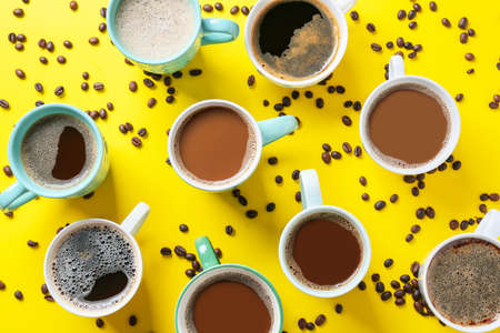 Cups of tasty coffee and beans on color backgroundの写真素材