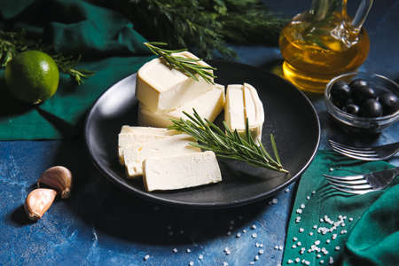 Plate with delicious feta cheese on color backgroundの写真素材