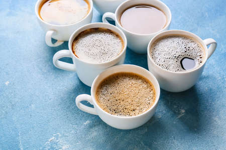 Cups of tasty coffee on color backgroundの写真素材