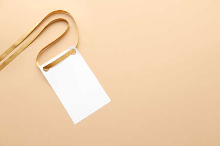 Golden ribbon with blank card on color backgroundの写真素材