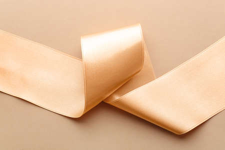 golden ribbon on color backgroundの写真素材