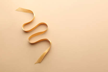 golden ribbon on color backgroundの写真素材