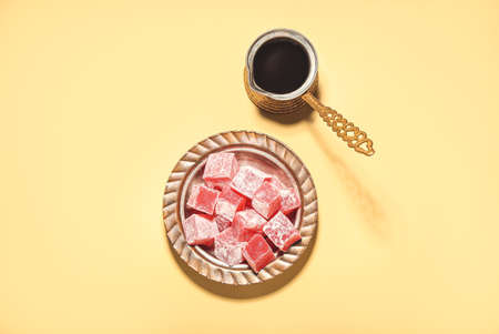 Turkish delight and coffee pot on color backgroundの写真素材