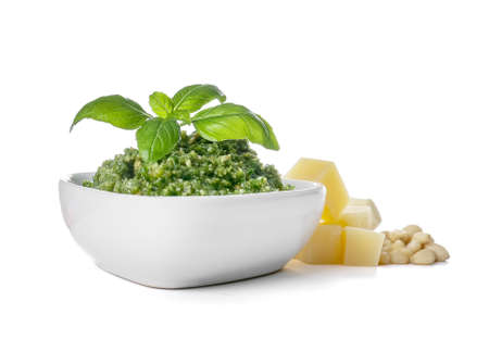 Bowl with fresh pesto sauce and ingredients on white backgroundの写真素材