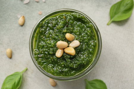 Bowl with fresh pesto sauce on color background, closeupの写真素材