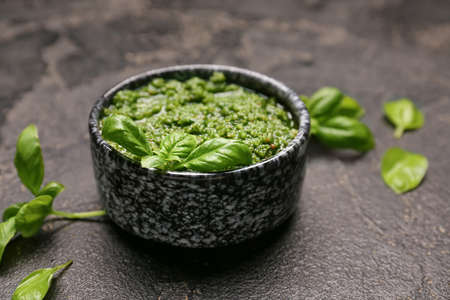 Bowl with fresh pesto sauce on dark backgroundの写真素材