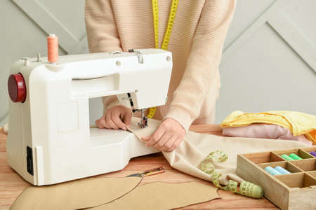 Woman sewing clothes on table